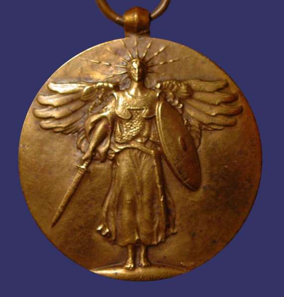 Fraser, James Earle, Peace of Versaille, 1919, Obverse
[b]Awarded to Charles Newton Rowlen of Champaign, Illinois[/b]

"In 1919 Fraser created a medal memorializing the Peace of Versailles.  On the obverse, a warrior goddess strides toward us wearing a radiant crown and breast plates.  She carries a shield and points her sword down, as a sign that the fighting has been completed.  The figure is vertically-centered, the out-stretched wings offer horizontal opposition.  The background is plain and smooth.  On the reverse the fasce surmounted by the blade of a double-headed battleaxe is seen against the U.S. Shield.  At the top edge of the round the inscription reads THE GREAT WAR FOR CIVILIZATION.  At the bottom, six five-pointed stars are well-spaced.  The participating countries are named and placed on either side of the shield.  On the left they are France, Italy, Serbia, Japan, Montenegro, Russia, and Greece.  On the right they are Great Britain, Belgium, Brazil, Portugal, Rumania, and China.  The overall effect is of clean, modern design.  An earlier version of the face shows only the fasce and battleaxe with four countries, America, France, Britain and Italy, and the date May 1919.  When required to add the names of additional signators of the treaty, Fraser was able to adapt the numerous additional letters to the basic design idea yet still keep his uncluttered feeling."

Quoted from: August L. Freundlich, "The Coins and Medals of James Earle Fraser, In [i]The Medal in America[/i], Edited by Alan M. Stahl, The American Numismatic Society, New York, 1998, pp. 191-193.

