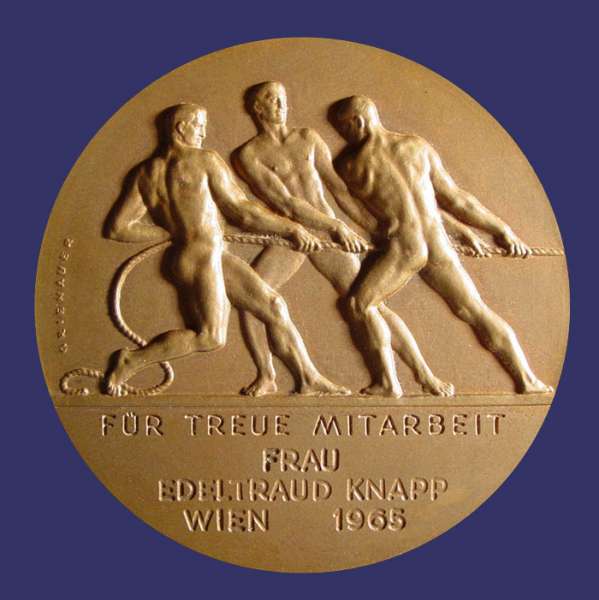 Fr Treue Mitarbeit, Bronze, 50 mm, Awarded 1965, Reverse
[b]From the collection of John Birks[/b]

This medal was designed by Edwin Grienauer for the "Kammer Der Gewerblichen Wirtschaft" (Chamber of the Commercial Economy of Vienna).  Edwin Grienauer was one of the more important Viennese Sculptors and Medalist of the 20th Century.  He was born March 7th, 1893 and by 1912, at age 19, he was already creating his first portrait plaques.  His body of work spans more than half a century.  Grienauer worked almost exclusively from commission and was proficient in all areas of sculptural design.  He died on August 21st, 1964.

These medals were issued over many years, exist in different sizes and metal compositions and have individualized dedications located below the three men on the reverse.  They were awarded for lengthy terms of service.

The obverse depicts Mercury carrying  a caduceus and a wreath.  In the background are the smoke stacks of industry at a riverside (Vienna is divided by the Danube River).  Across the bottom is inscribed "Fr Wien" and around the rim, "Kammer Der Gewerblichen Wirtschaft" (Chamber of the Commercial Economy of Vienna).  The reverse depicts three men in a classical style cooperating in pulling a load.   Below the image is the inscription "Fr Treue Mitarbeit" (For Loyal Dedication) "Frau Edeltraud Knapp Wien 1965" (Mrs. Edeltraud Knapp, Vienna 1958).

The medal work of Grienauers consists mainly of commissioned pieces for his customers and this aspect of his work is dominated by award/service medals of national or economic institutions and prizes for sporting events.  His large sculptures are still present today in Vienna and include reliefs and architectural sculptures, crucifixes and religious statues on and in Viennese churches, and even floor tiles for the St Stephans Cathedral.

Works include coinage dies of the Austrian 1st and 2nd Republic, medals, sculptures, and portraits.  He designed commemorative and regular issue coins for Liechtenstein as well.  Grienauer designed the denomination side of the last of the Schilling coins of Austria, which were in circulation from 1959 to 2002.

Keywords: nude male Edwin Grienauer