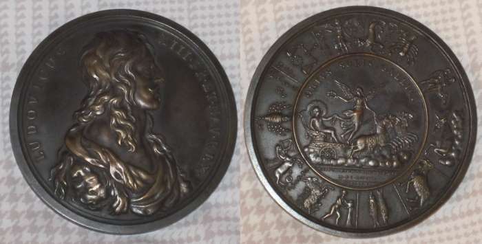 Birth of Louis XIV
Bronze medal ("bronze" and cornucopia struck on edge)  7.1 cm, obverse with head of Ludovicus XIII FR.ET.NAV.REX (Louis XIII king of France and Navarre), reverse showing the disposition of the zodiac at the moment of the birth of his son and heir the future Louis XIV, center with the legend ORTUS SOLIS GALLICI (rising of the sun of France) above the carriage of the sun and below the inscription SEPT V.HOR XI.MIN XXII.ANTE.MER. and Molart F.[ecit]. This, apparently a 19th century copy. A reference to the original is at http://www.archive.org/stream/histoiredvroylov01mene/histoiredvroylov01mene_djvu.txt. The same obverse used with a different reverse can be see at http://www.kunstpedia.org/articles/-3.html. 
Keywords: Louis_XIII Louis_XIV