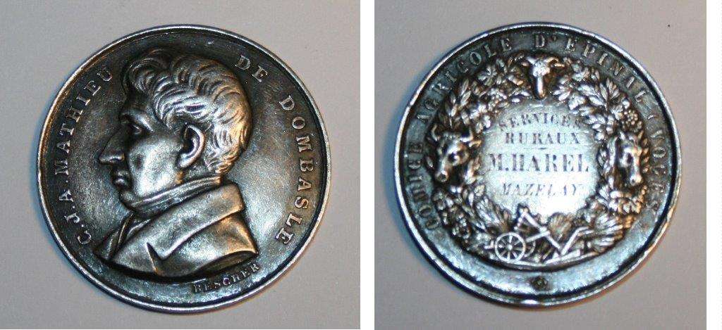 Mathieu De Dombasle by Bescher, Combo
Agricultural French award medal in Argent, to M. Harel.  Mathieu was a very interesting character.  Invented the Dombasle Plow. , Dombasle has advanced the technique of sugar extraction and proposals, neglected at the time, imposed by the suite1. It was also in 1810 that Mathieu Dombasle began to publish, with a brochure analyzes of natural waters by reagents, and he brought from Switzerland and Belgium, later in England, various implements for its fields beet.

In 1817 Dombasle attaches to Nancy and began to publish agronomic texts on crystallization of the sugar, manufacture of potato water spirits, the operation of various types of plows ... In 1821, s 'drawing on more anciensN 2 works Dombasle publishes the Calendar of good farmer who describes good agricultural practices throughout the year1.
"Best Farm" Roville

 In 1801, Mathieu Dombasle made a trip to Paris where he met with smallpox marks the physically with a loss of visual acuity. The following year, he suffered an accident in which the iron wheel of a car passes him on the leg: it limp all his life. This series of unfortunate events made the "taciturn and away from the world3".

    "He was of high stature. He always walked with his head bowed forward because his eyesight was poor; his black eyes had little sparkle, but his serious face, pensive, indicated he took pleasure in intellectual work "

- Gustave Heuz, Journal of practical agriculture, 1894

Keywords: Dombasle Bescher French  Agricultural agriculture Farming
